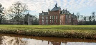 Plombier Grâce-Hollogne centre-ville rue bordée de maisons en briques typiques avec enseignes locales et commerces accueillants